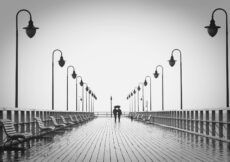 two people walking on pier